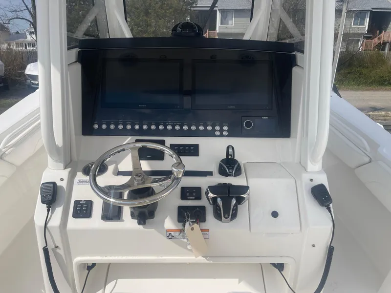 Slide: The Image of 2022 Regulator 31 boat dashboard with steering wheel and control panel. - 12