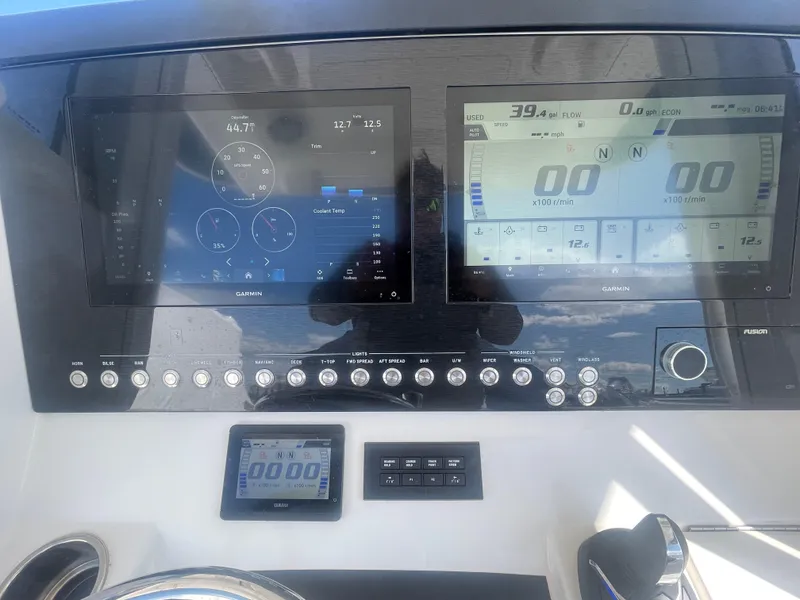 Slide: The Image of Control panel of a 2022 Regulator 31 boat with digital displays and gauges. - 14