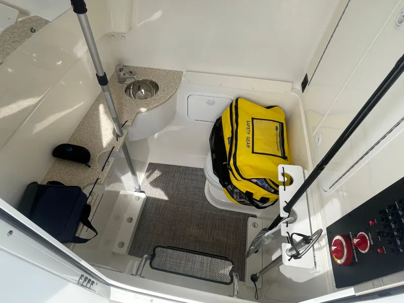 Slide: The Image of 2022 Regulator 31 boat interior with storage, sink, and safety equipment. - 15