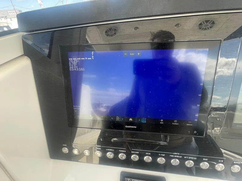 Slide: The Image of Garmin display on 2022 Regulator 31 boat dashboard, showing navigation data. - 16