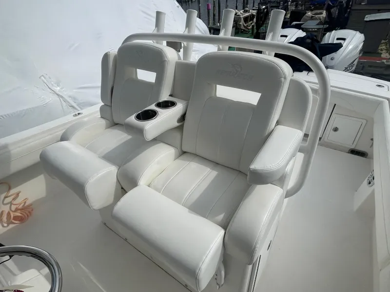 Slide: The Image of 2022 Regulator 31 boat with white cushioned seats and cup holders. - 25