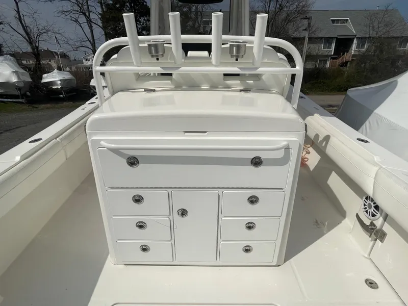 Slide: The Image of 2022 Regulator 31 boat with white storage console and rod holders. - 27