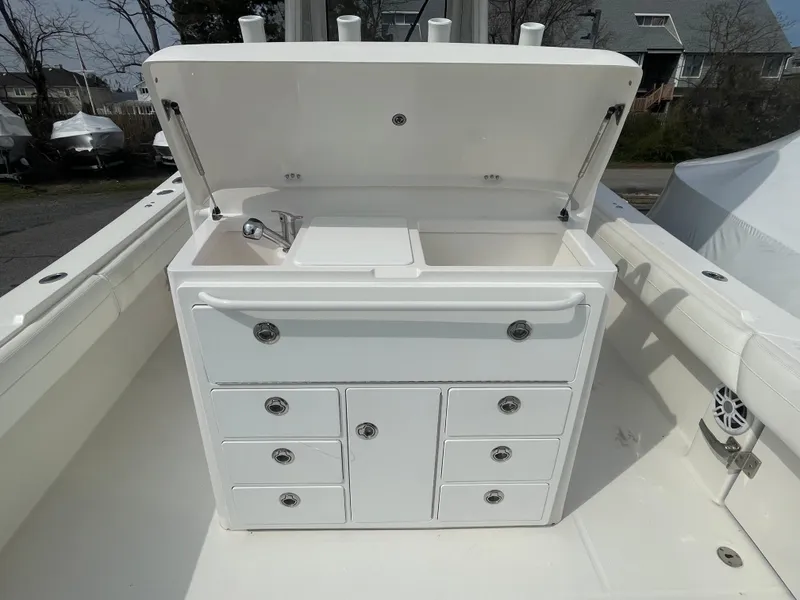 Slide: The Image of 2022 Regulator 31 boat with open storage compartment and sink. - 28
