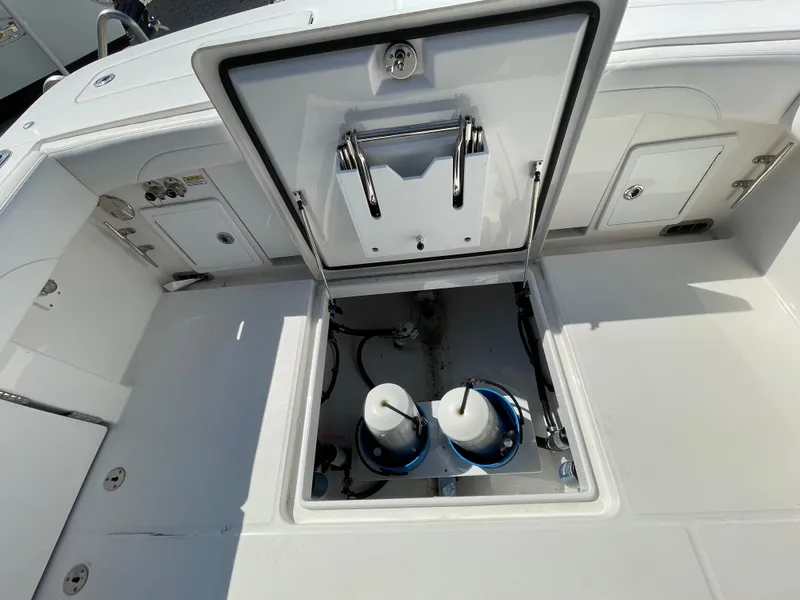 Slide: The Image of 2022 Regulator 31 boat deck with open hatch revealing storage compartment. - 29