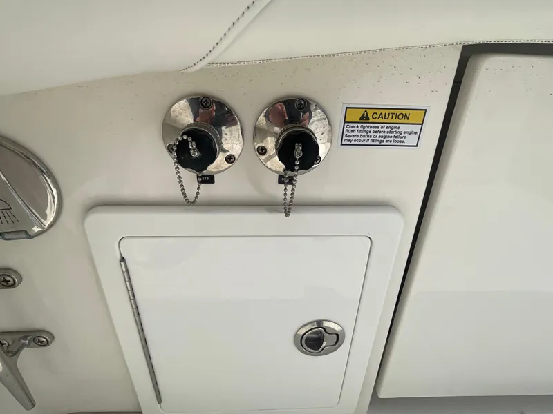 Slide: The Image of 2022 Regulator 31 boat fuel caps and caution label on white panel. - 30