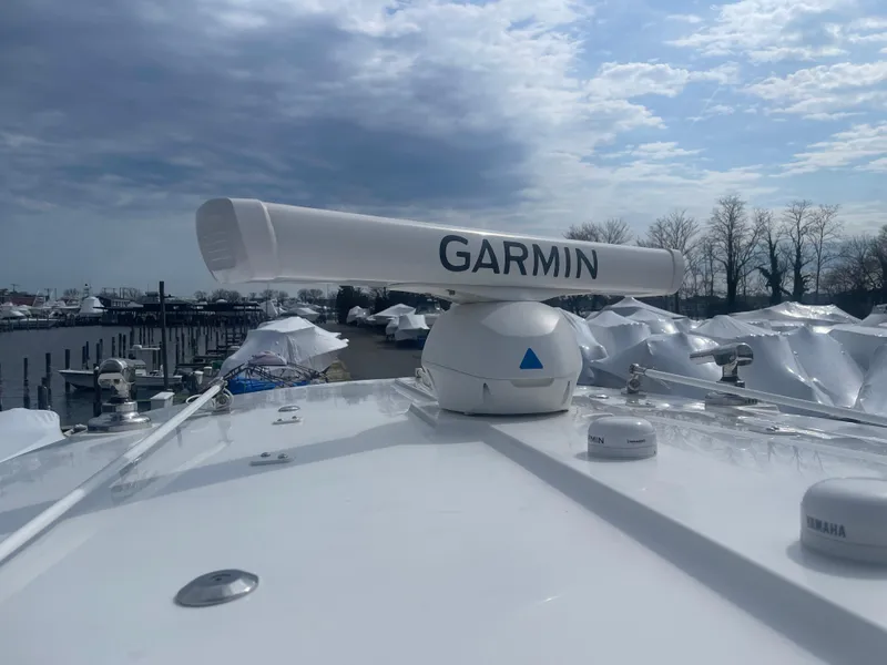 Slide: The Image of 2022 Regulator 31 boat with Garmin radar, docked under cloudy sky. - 31