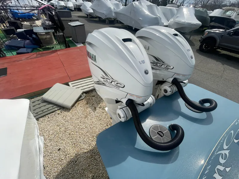 Slide: The Image of Twin Yamaha outboard engines on a 2022 Regulator 31 boat, parked on gravel. - 33