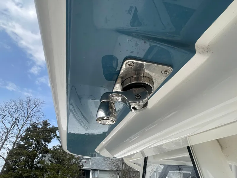 Slide: The Image of 2022 Regulator 31 boat detail showing a stainless steel fitting under a blue canopy. - 34