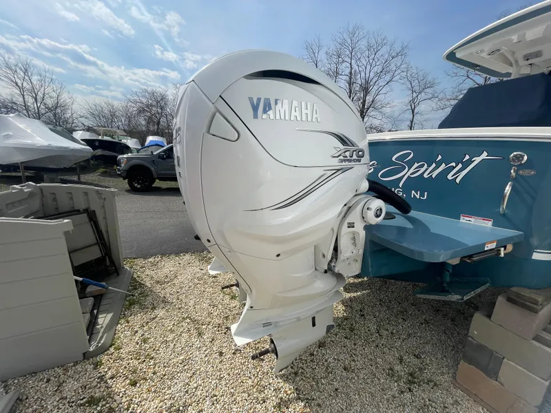 Slide: The Image of 2022 Regulator 31 boat with Yamaha XTO outboard motor, parked on gravel. - 35