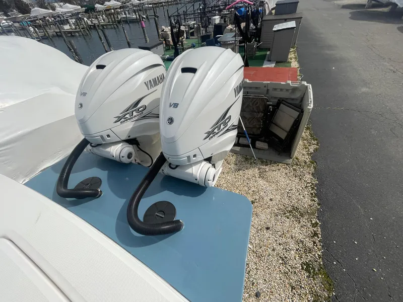 Slide: The Image of Twin Yamaha V8 outboard engines on a 2022 Regulator 31 boat at a marina. - 37