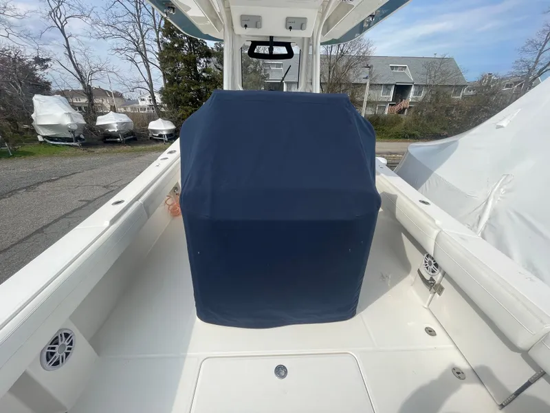 Slide: The Image of 2022 Regulator 31 boat interior with covered console, docked outdoors. - 39