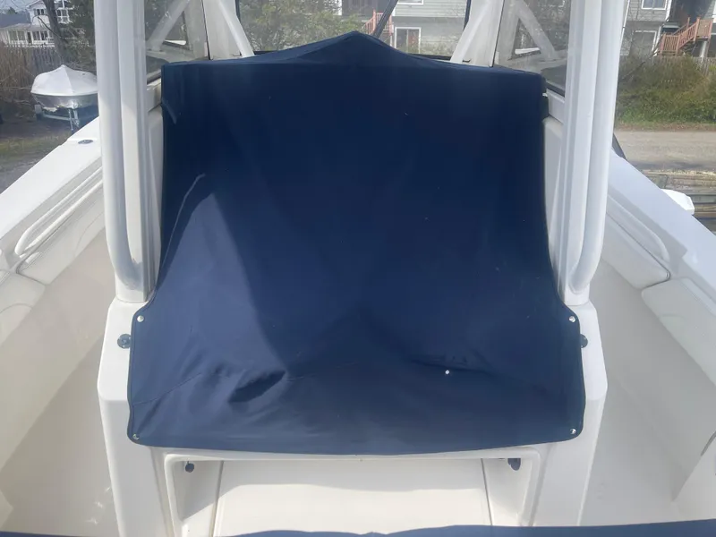 Slide: The Image of 2022 Regulator 31 boat with a blue canvas cover on the seating area. - 40