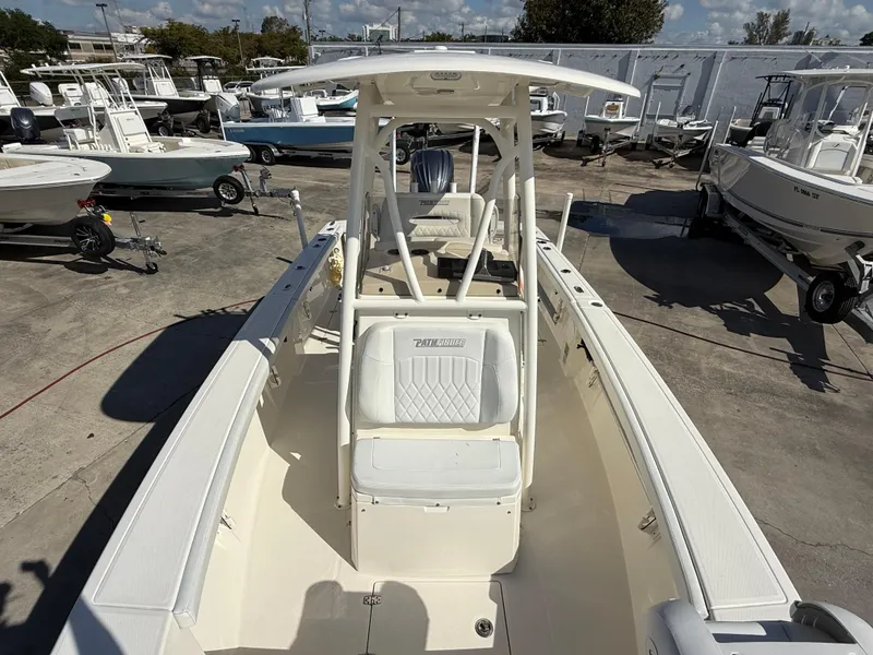 Slide: The Image of 2023 Pathfinder 2400 Open boat, white interior, docked among other boats. - 10