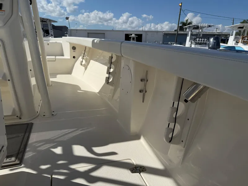 Slide: The Image of 2023 Pathfinder 2400 Open boat interior with rod holders and storage compartments. - 12