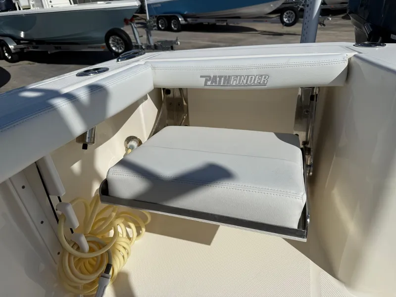 Slide: The Image of 2023 Pathfinder 2400 Open boat seat with storage compartment and coiled rope. - 15