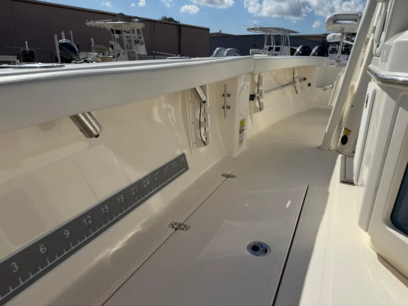 Slide: The Image of 2023 Pathfinder 2400 Open boat deck with rod holders and measurement scale. - 17