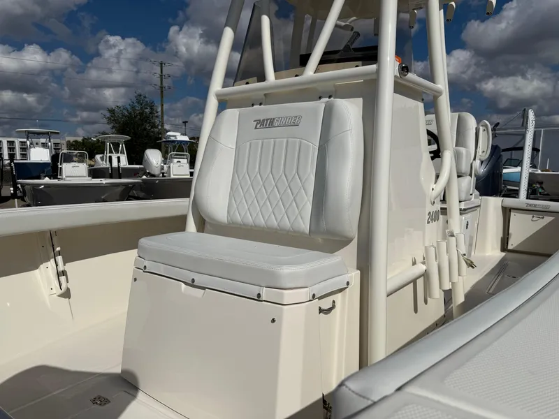 Slide: The Image of 2023 Pathfinder 2400 Open boat interior with cushioned seating under a blue sky. - 3
