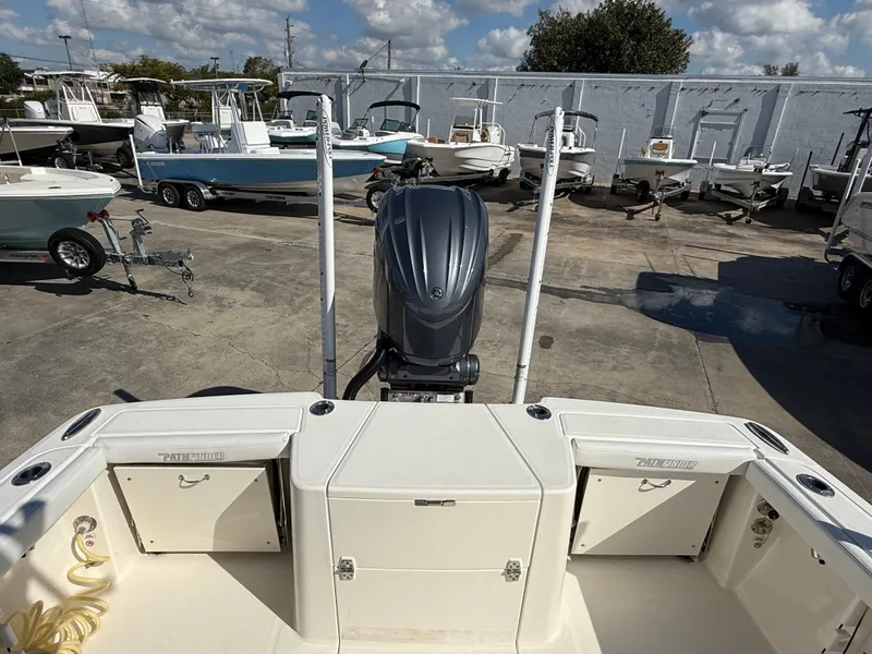 Slide: The Image of 2023 Pathfinder 2400 Open boat with outboard motor in a marina setting. - 7