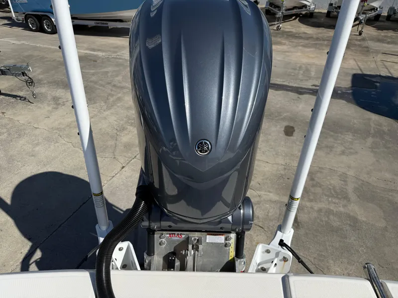 Slide: The Image of 2023 Pathfinder 2400 Open boat with a sleek outboard motor in a marina setting. - 8