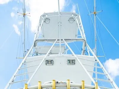 Slide: The Image of 1999 Viking Express boat tower against a bright blue sky with clouds. - 1