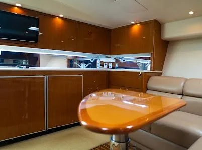 Slide: The Image of Luxurious interior of a 1999 Viking Express yacht with wooden cabinetry and plush seating. - 10