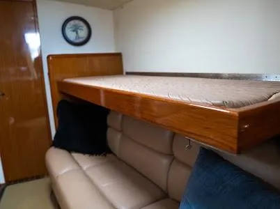 Slide: The Image of Interior of 1999 Viking Express with leather seating and wooden bunk bed. - 11