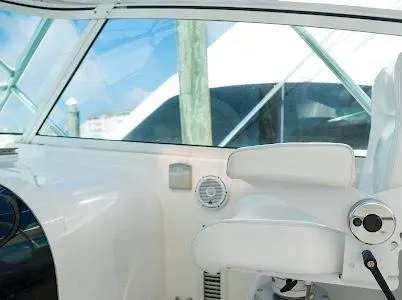 Slide: The Image of Interior of a 1999 Viking Express boat, featuring a white captain's chair and window view. - 14