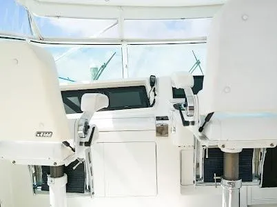 Slide: The Image of 1999 Viking Express boat cockpit with white captain chairs and control panel. - 16