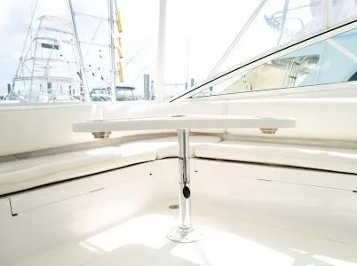 Slide: The Image of 1999 Viking Express boat interior with white seating and table. - 17