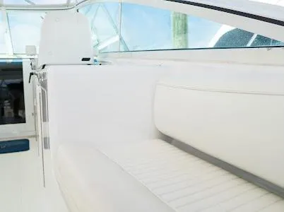 Slide: The Image of 1999 Viking Express boat interior with white seating and helm, showcasing sleek design. - 18