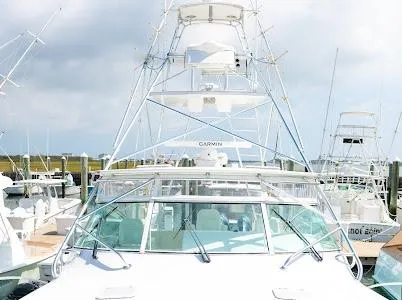 Slide: The Image of 1999 Viking Express boat docked at marina under cloudy sky. - 22