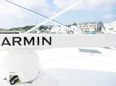 Slide: The Image of Garmin radar on 1999 Viking Express boat, marina background, clear sky. - 24