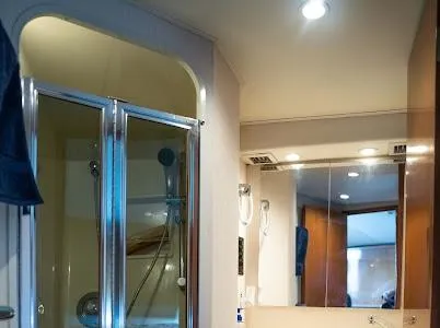 Slide: The Image of Bathroom interior of a 1999 Viking Express with shower and mirror. - 4