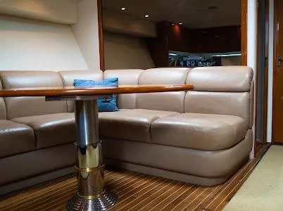 Slide: The Image of Luxurious interior of 1999 Viking Express yacht with leather seating and wooden table. - 9