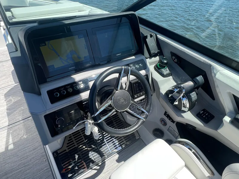 Slide: The Image of 2022 Cobalt R8 Outboard boat dashboard with steering wheel and navigation screens. - 12