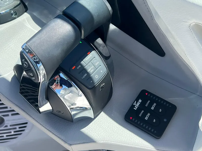 Slide: The Image of Throttle controls of a 2022 Cobalt R8 Outboard boat with Lenco trim tab switch. - 13