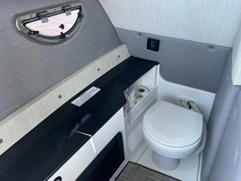 Slide: The Image of 2022 Cobalt R8 Outboard boat interior with compact bathroom and modern amenities. - 19
