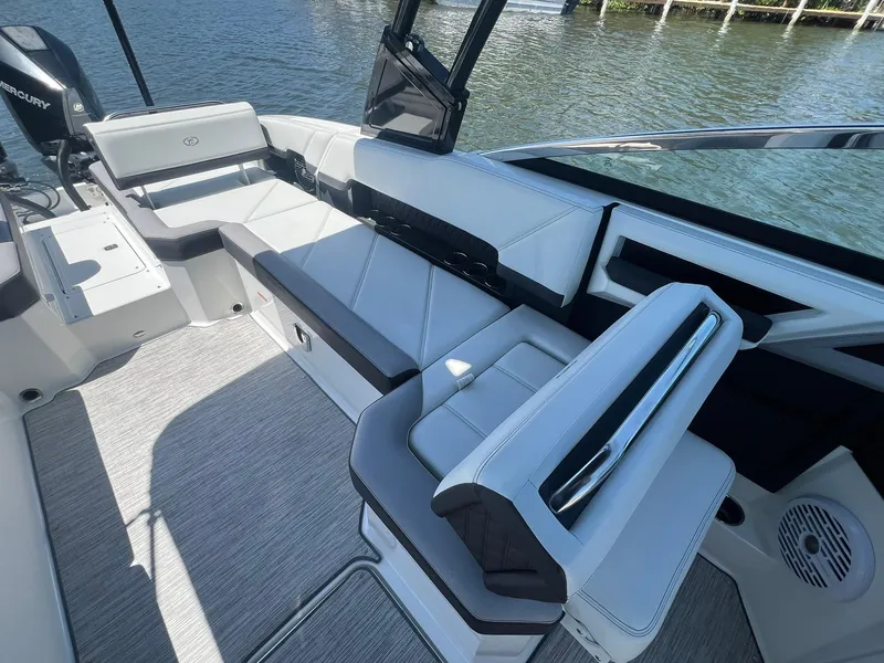 Slide: The Image of 2022 Cobalt R8 Outboard boat interior with sleek seating and modern design on the water. - 21