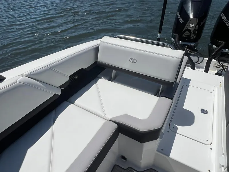 Slide: The Image of 2022 Cobalt R8 Outboard boat interior with white seating and water in the background. - 23