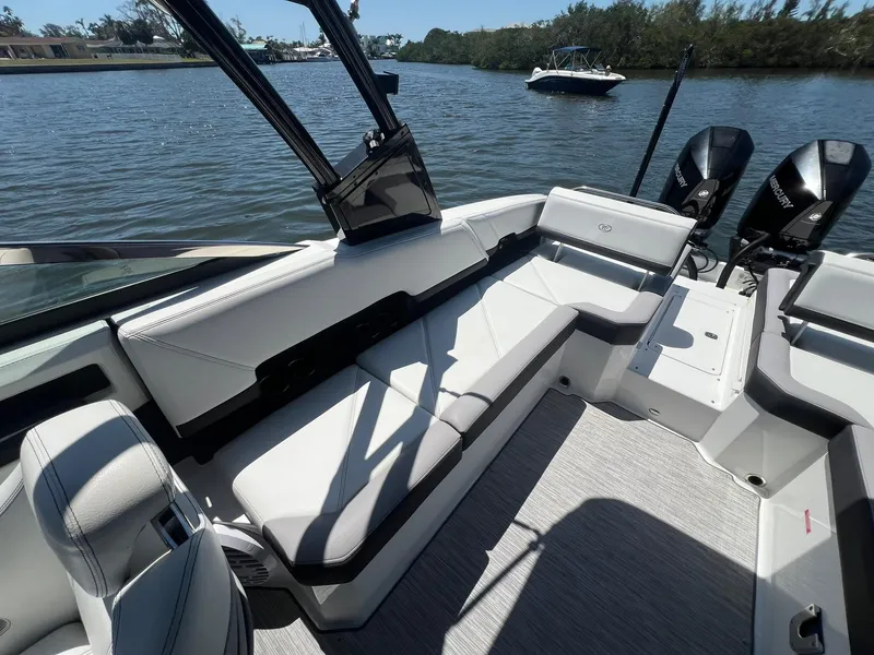 Slide: The Image of 2022 Cobalt R8 Outboard boat interior with sleek seating, on a calm waterway. - 25