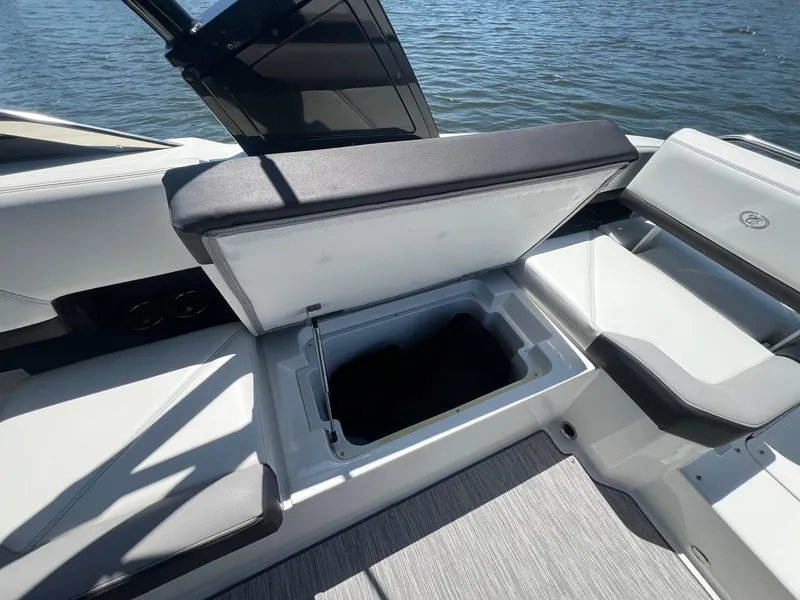 Slide: The Image of 2022 Cobalt R8 Outboard boat with open storage compartment, showcasing sleek interior design. - 27