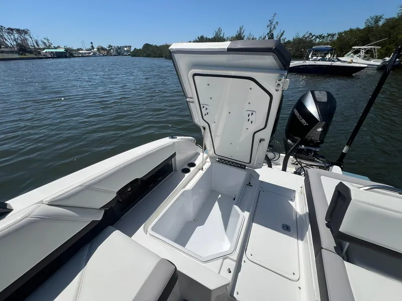 Slide: The Image of 2022 Cobalt R8 Outboard boat with open storage compartment on a calm lake. - 28