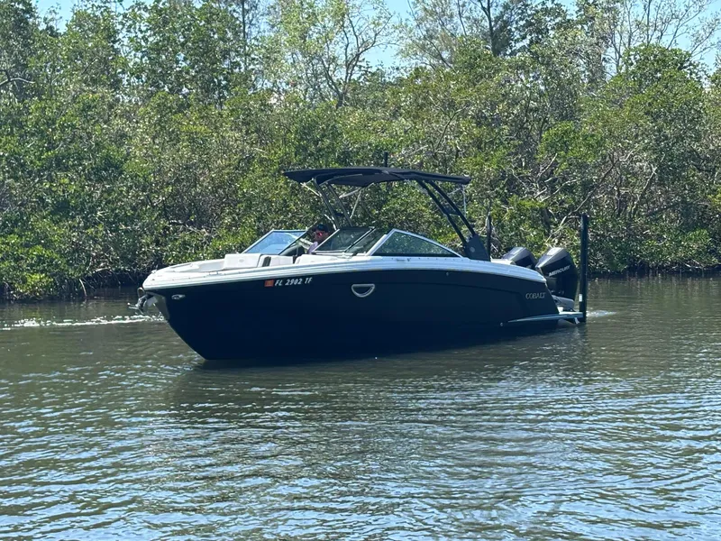 Slide: The Image of 2022 Cobalt R8 Outboard boat cruising on a calm river surrounded by lush greenery. - 3