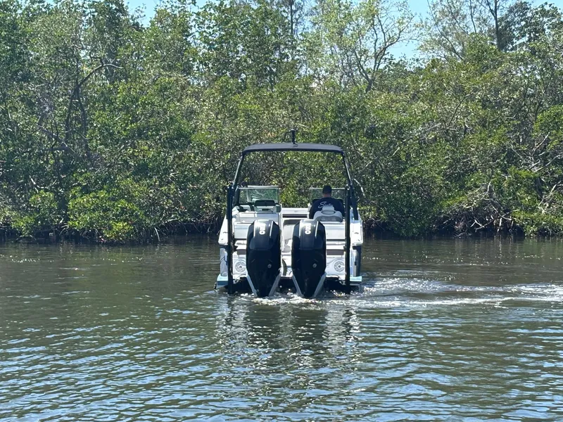 Slide: The Image of 2022 Cobalt R8 Outboard boat navigating through a lush, green waterway. - 5