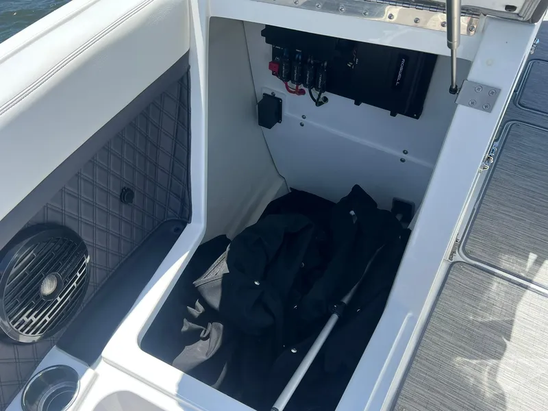 Slide: The Image of 2022 Cobalt R8 Outboard storage compartment with speaker and equipment. - 9