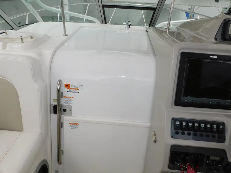 Slide: The Image of 2008 Robalo R305 Walkaround cockpit with control panel and seating area. - 11