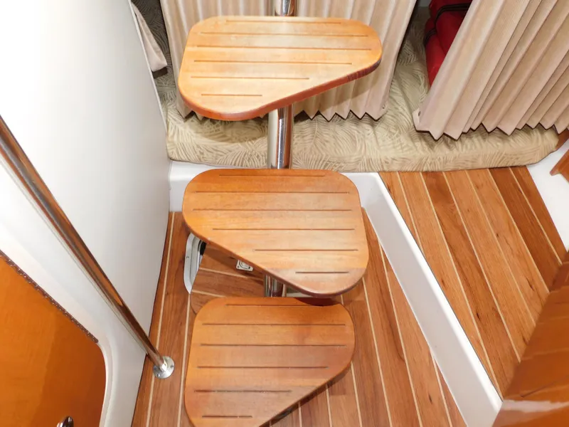 Slide: The Image of Wooden steps inside a 2008 Robalo R305 Walkaround boat cabin. - 24