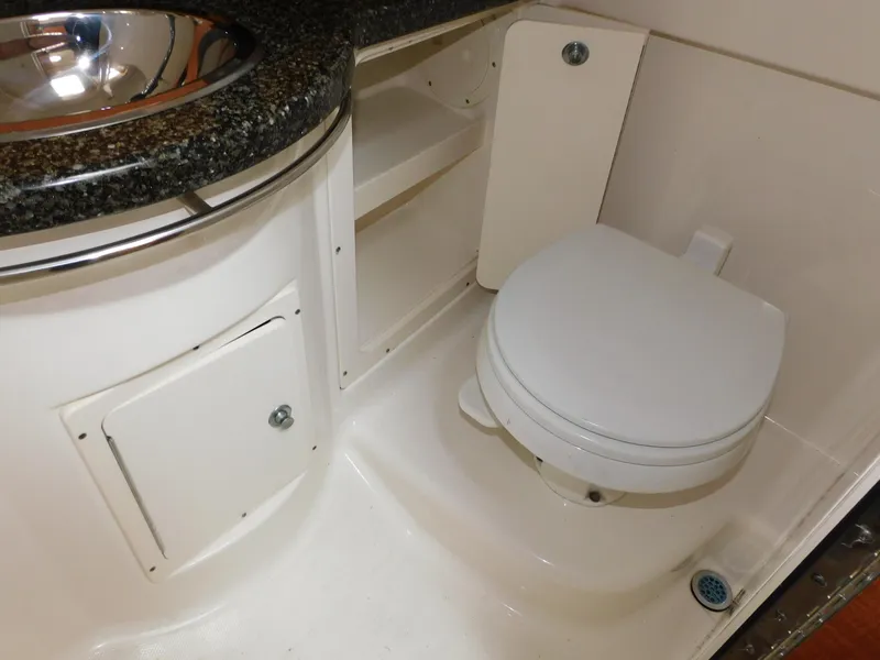 Slide: The Image of 2008 Robalo R305 Walkaround boat bathroom with toilet and sink. - 26