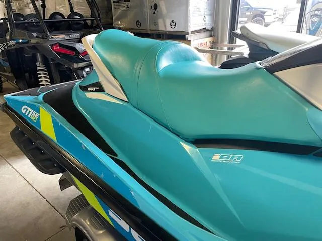 Slide: The Image of 2016 Sea-Doo GTI 130 SE jet ski with turquoise seat in showroom. - 4