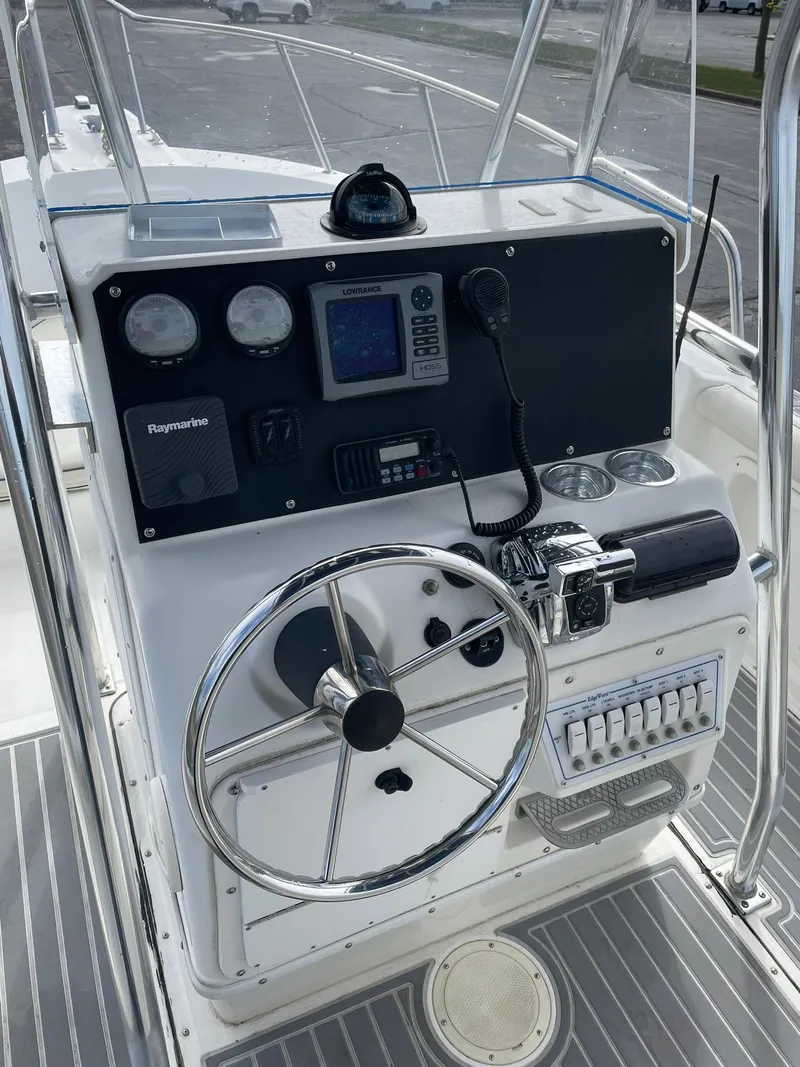Slide: The Image of Edgewater 220CC 2000 boat console with steering wheel and navigation instruments. - 13
